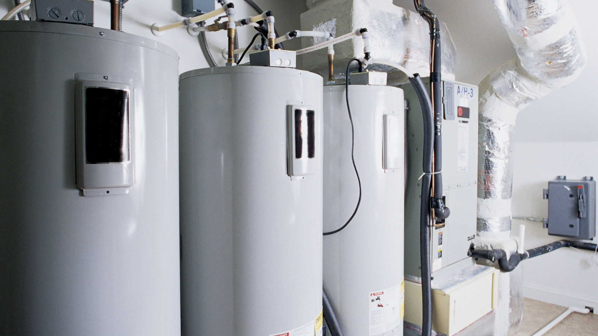 A couple of water heaters sitting next to each other